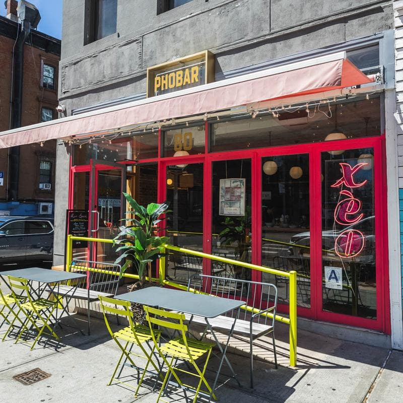 PhoBar's current red storefront and outdoor seating at 80 6th Avenue